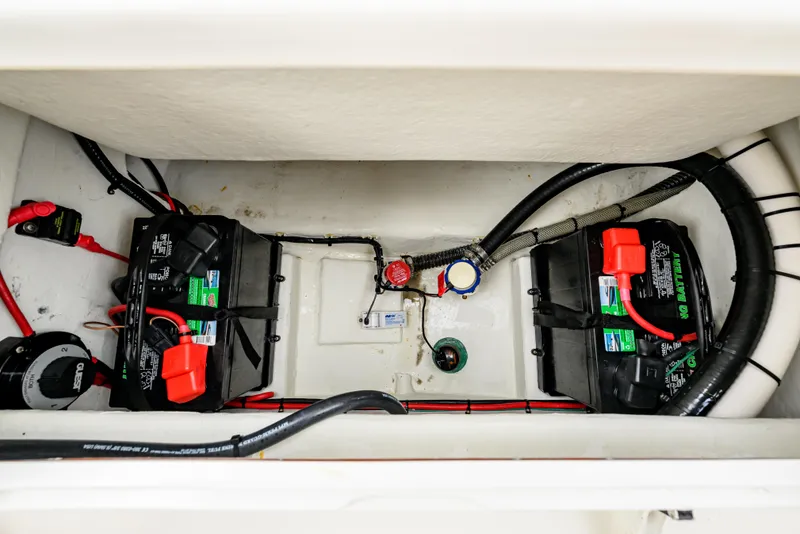 Slide: The Image of Battery compartment of 2018 Parker 21 Special Edition boat with wiring and connections. - 19