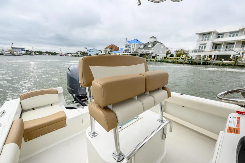 Slide: The Image of 2018 Parker 21 Special Edition boat interior with tan seating, dockside view. - 9