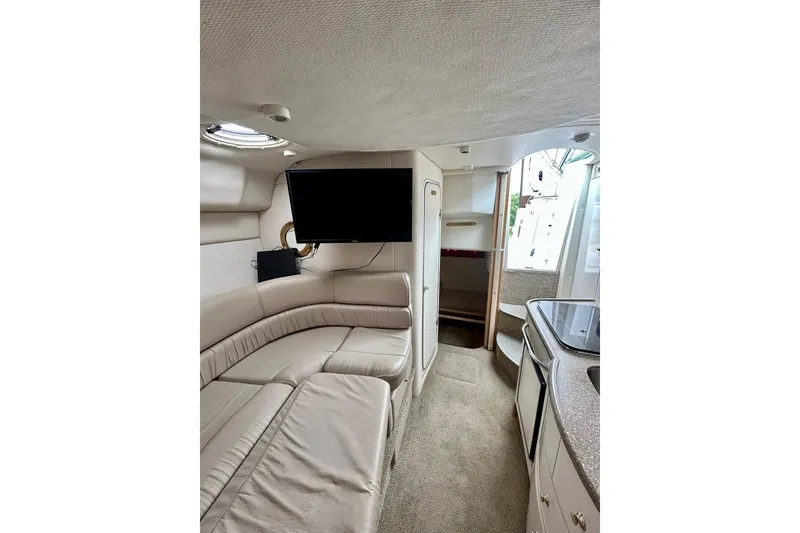 Slide: The Image of Interior of 2000 Maxum 3000 SCR boat with beige seating and modern amenities. - 10