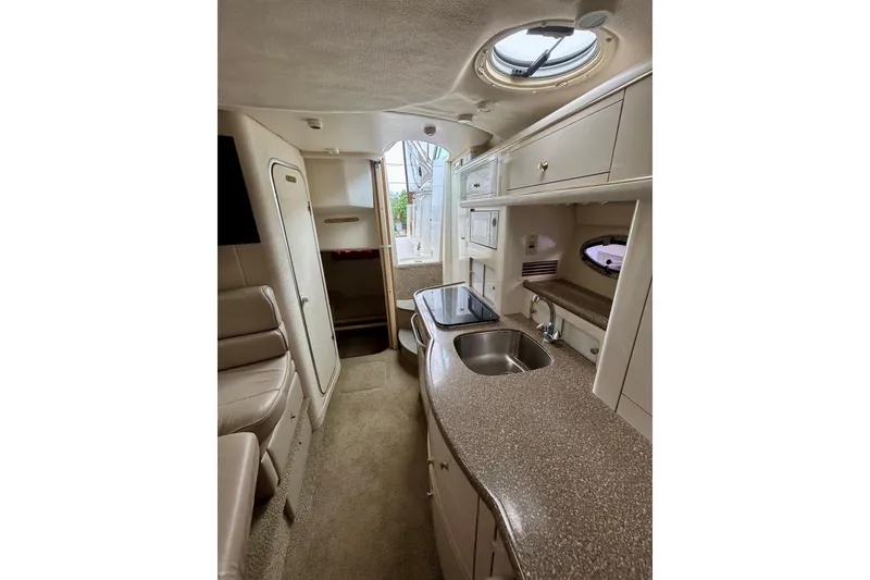 Slide: The Image of Interior of 2000 Maxum 3000 SCR boat with kitchenette and seating area. - 11
