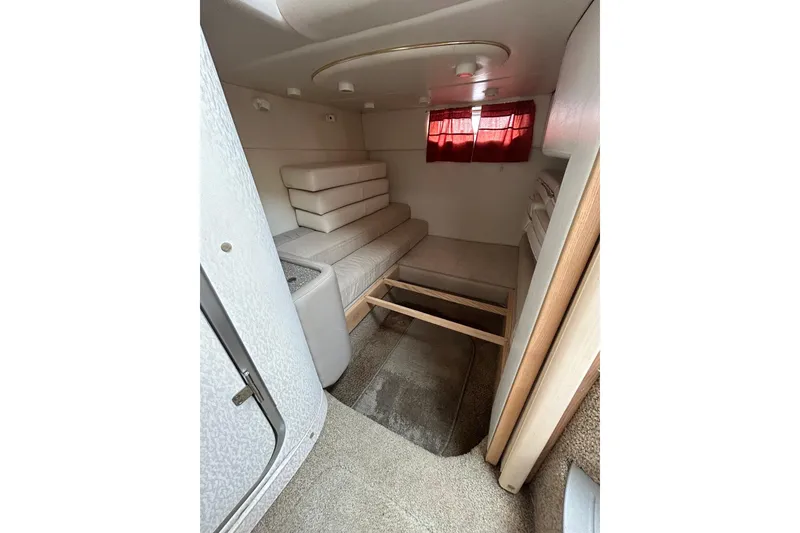 Slide: The Image of Interior cabin of 2000 Maxum 3000 SCR boat with seating and red curtains. - 12