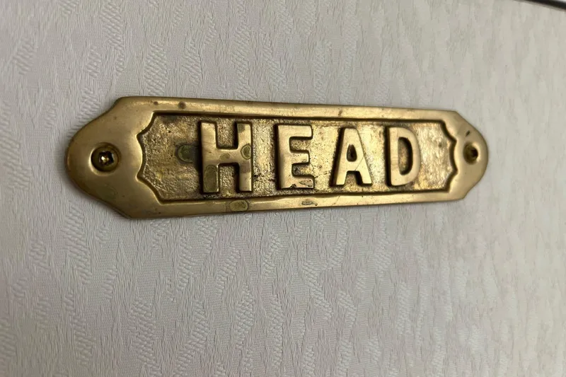 Slide: The Image of Brass "Head" sign on 2000 Maxum 3000 SCR boat interior wall. - 16