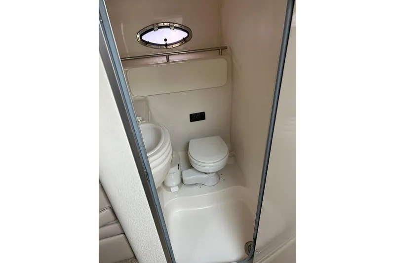 Slide: The Image of Compact bathroom in 2000 Maxum 3000 SCR boat with toilet and porthole window. - 18