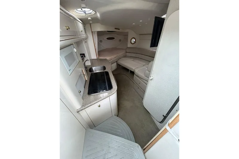 Slide: The Image of Interior of 2000 Maxum 3000 SCR boat with kitchenette and seating area. - 19