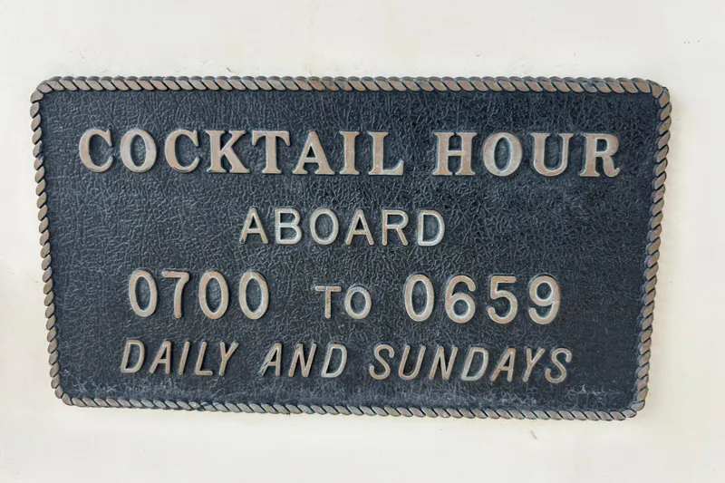 Slide: The Image of Plaque on Maxum 3000 SCR boat: "Cocktail Hour Aboard 0700 to 0659 Daily and Sundays." - 20