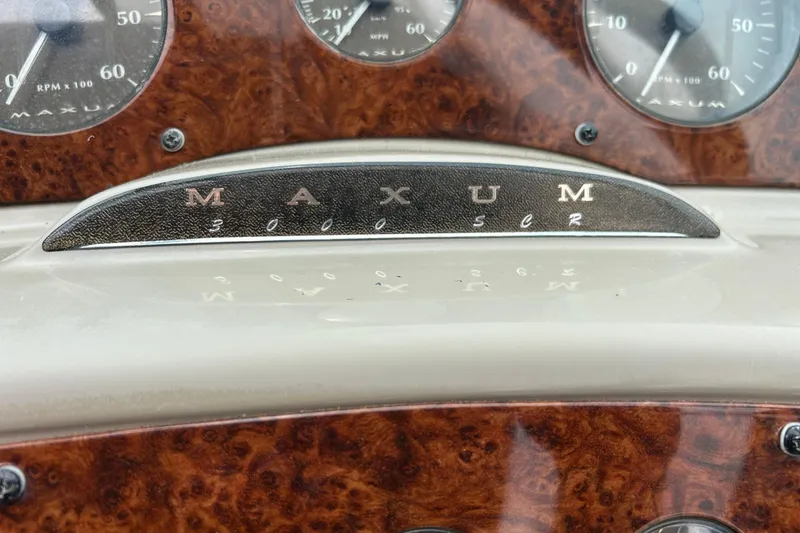 Slide: The Image of Dashboard of 2000 Maxum 3000 SCR boat with wood grain finish and gauges. - 23