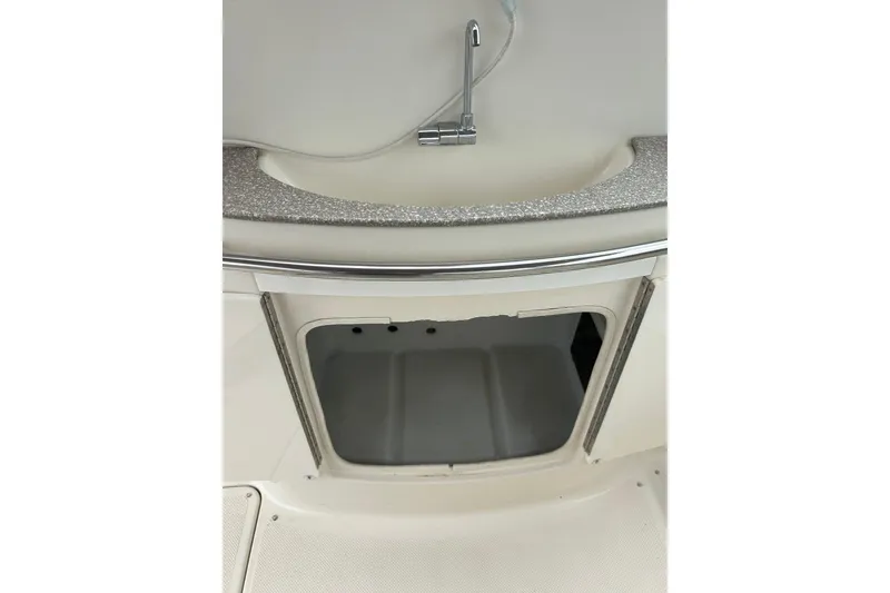 Slide: The Image of Maxum 3000 SCR 2000 boat interior with open storage compartment and sink. - 27