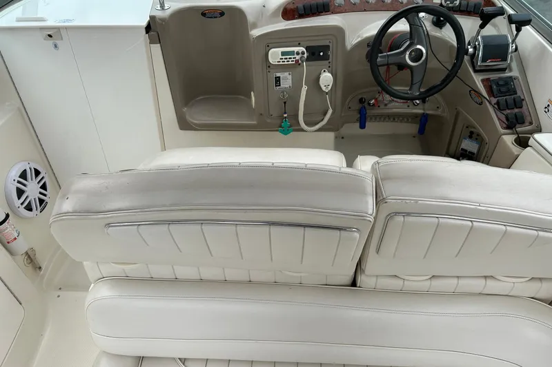 Slide: The Image of Interior of 2000 Maxum 3000 SCR boat with steering wheel and white seating. - 28