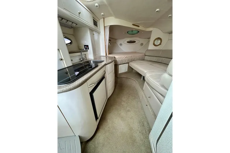 Slide: The Image of Interior of 2000 Maxum 3000 SCR boat with kitchenette and seating area. - 3