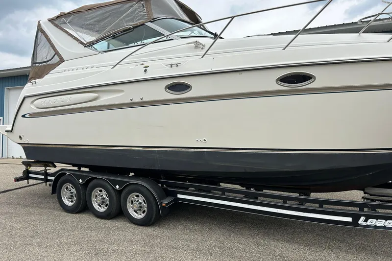 Slide: The Image of 2000 Maxum 3000 SCR boat on trailer, side view, beige and black color scheme. - 35