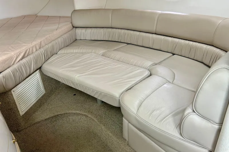 Slide: The Image of Interior of 2000 Maxum 3000 SCR boat with beige leather seating and carpeted floor. - 7