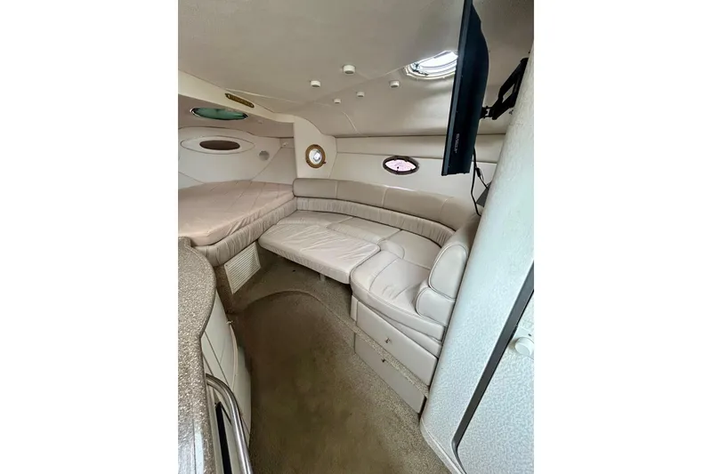 Slide: The Image of Interior of 2000 Maxum 3000 SCR boat with beige seating and modern amenities. - 9
