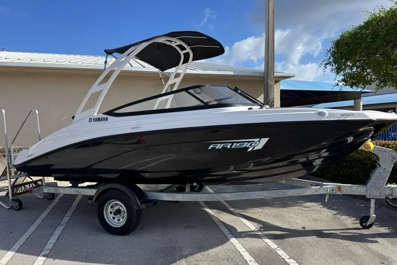The Image of 2025 Yamaha Boats AR190 on trailer, sleek design under clear blue sky. - 0