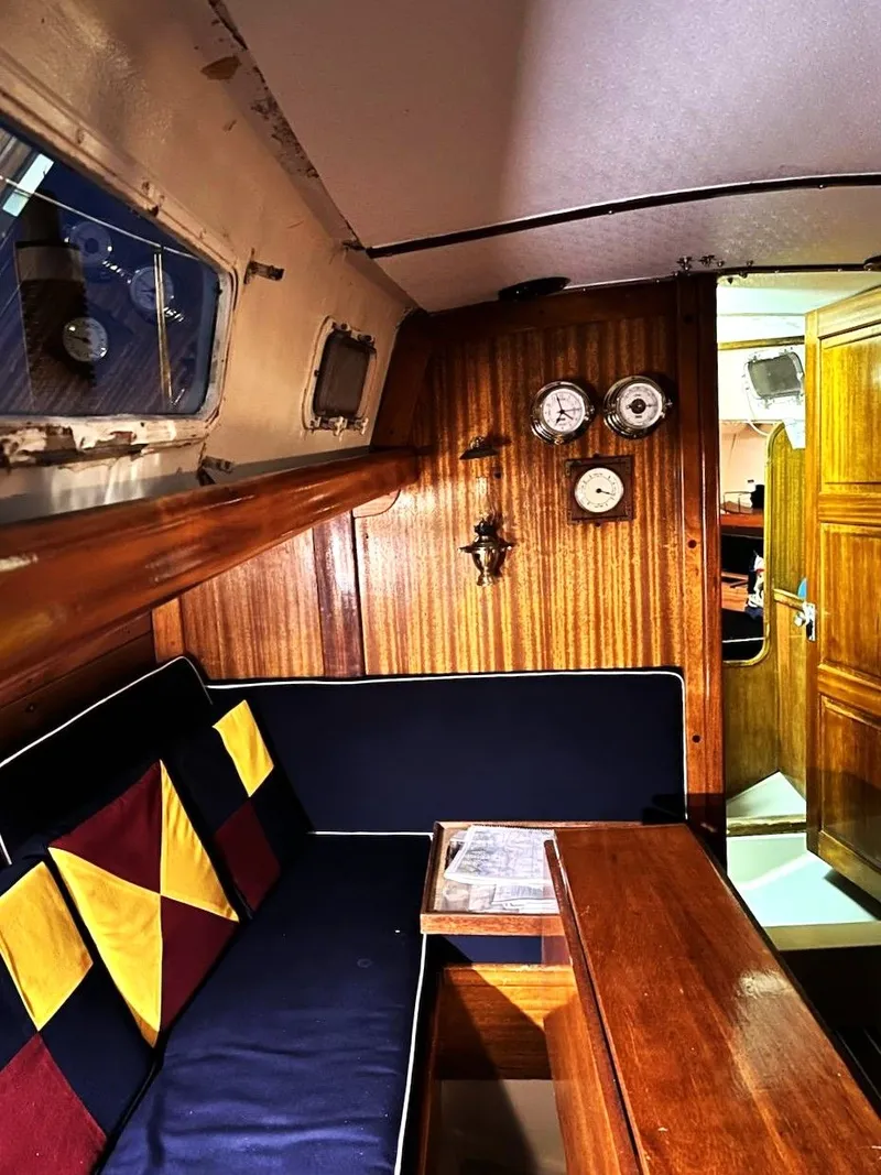 Slide: The Image of Interior of 1967 Jensen Cal 36 sailboat with wooden paneling and nautical decor. - 22
