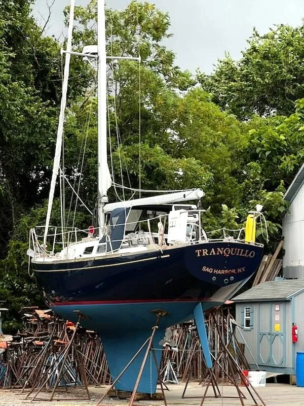 Slide: The Image of 1967 Jensen Cal 36 sailboat "Tranquillo" on stands, Sag Harbor, surrounded by trees. - 35