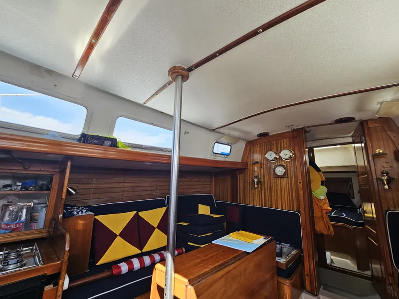 Slide: The Image of Interior of a 1967 Jensen Cal 36 sailboat with wood paneling and nautical decor. - 16