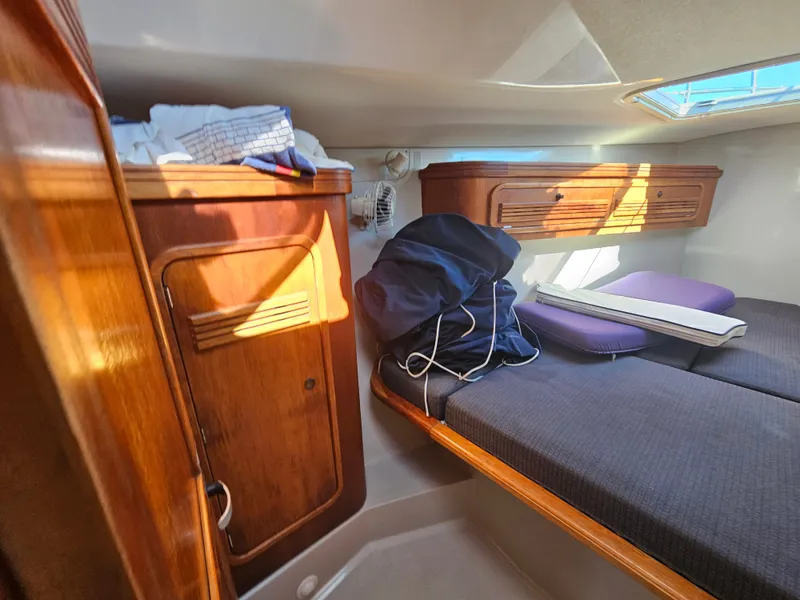 Slide: The Image of Cozy cabin interior of 1967 Jensen Cal 36 sailboat with wooden storage and bedding. - 18