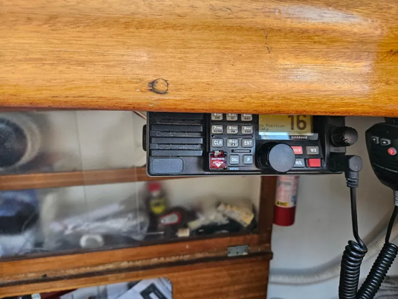 Slide: The Image of Marine radio equipment inside a 1967 Jensen Cal 36 sailboat, featuring a wooden interior. - 26
