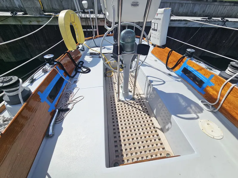 Slide: The Image of 1967 Jensen Cal 36 sailboat deck with wooden accents and nautical equipment. - 9