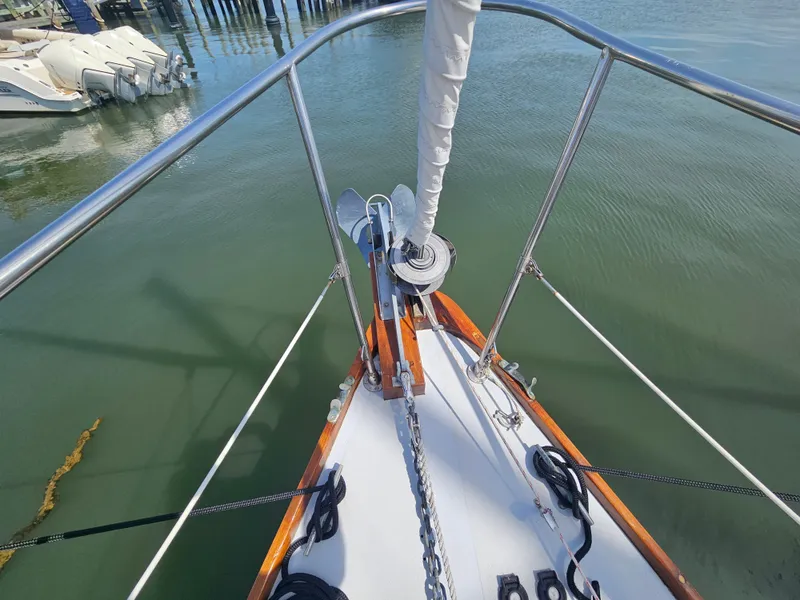 Slide: The Image of Bow of 1967 Jensen Cal 36 sailboat with anchor chain and calm water. - 5