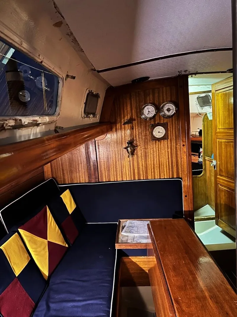 Slide: The Image of Interior of a 1967 Jensen Cal 36 sailboat with wooden paneling and nautical decor. - 15