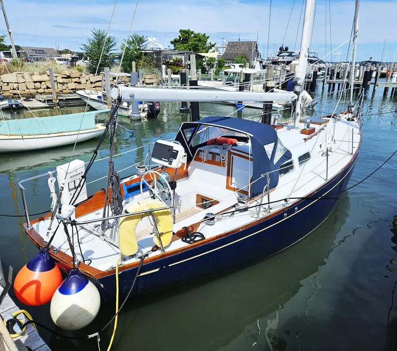 Slide: The Image of 1967 Jensen Cal 36 sailboat docked in a marina, featuring a sleek design and vibrant colors. - 3