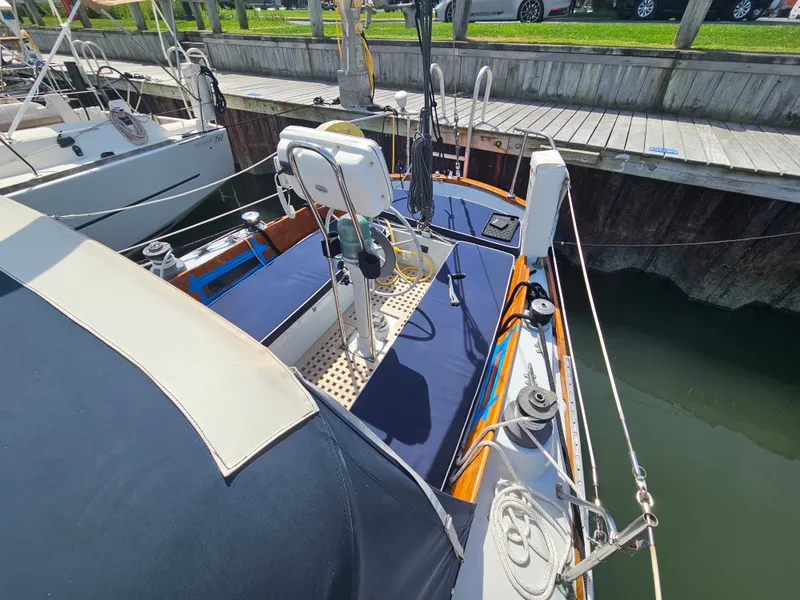 Slide: The Image of 1967 Jensen Cal 36 sailboat docked, featuring a clean deck and modern equipment. - 8