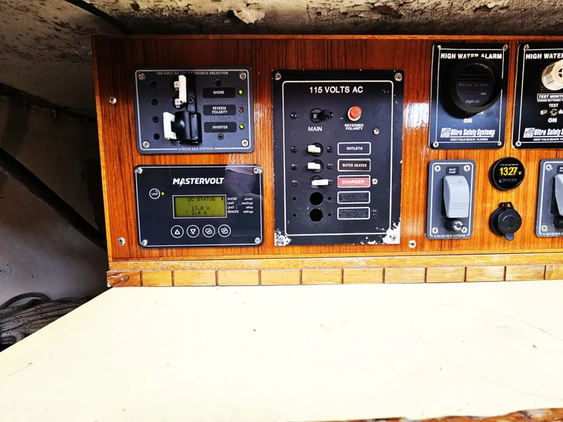 Slide: The Image of Electrical control panel on a 1967 Jensen Cal 36 boat, featuring various switches and gauges. - 27