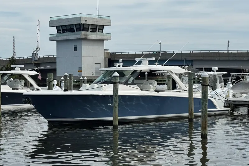 The Image of 2023 Tiara Yachts 43 LS docked near a control tower. - 0