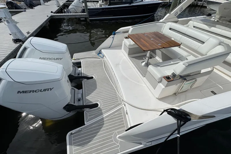 Slide: The Image of 2023 Tiara Yachts 43 LS with dual Mercury engines and elegant seating area. - 10