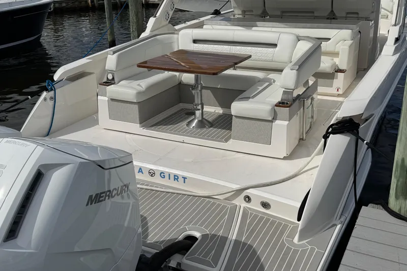Slide: The Image of 2023 Tiara Yachts 43 LS with luxurious seating and Mercury engine at dock. - 14