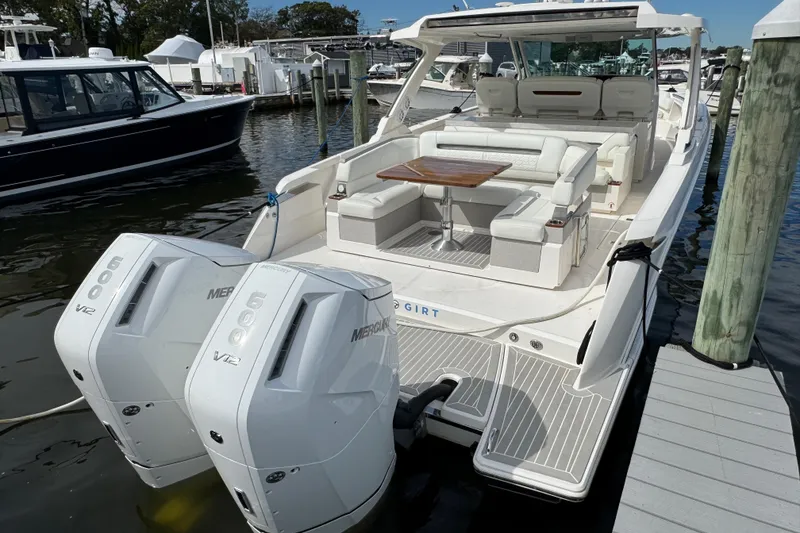 Slide: The Image of 2023 Tiara Yachts 43 LS with twin Mercury 600 V12 engines docked at marina. - 15