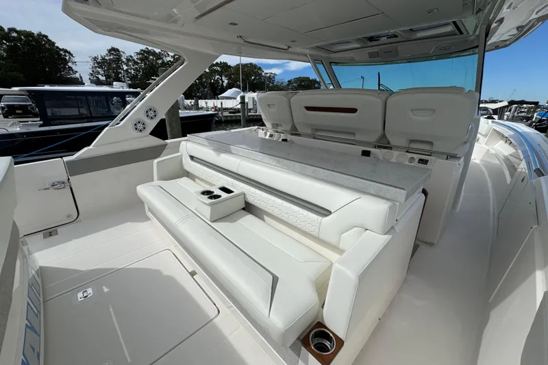 Slide: The Image of 2023 Tiara Yachts 43 LS interior with luxurious white seating and modern design. - 17