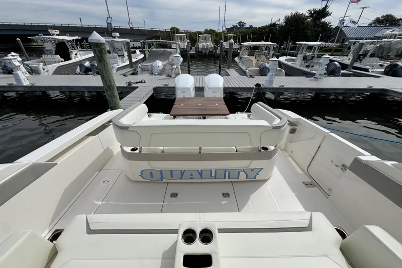 Slide: The Image of 2023 Tiara Yachts 43 LS at dock, showcasing spacious seating and sleek design. - 19