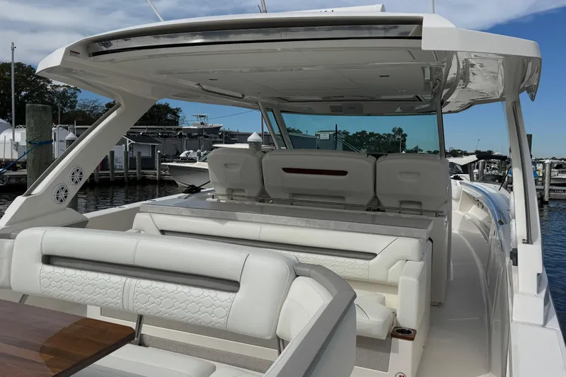 Slide: The Image of 2023 Tiara Yachts 43 LS luxury boat interior with white seating and sleek design. - 20