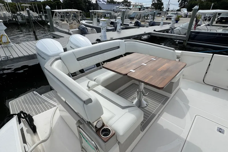 Slide: The Image of 2023 Tiara Yachts 43 LS with seating and table, docked at marina. - 24
