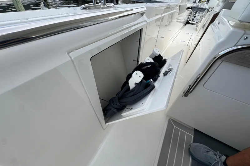 Slide: The Image of 2023 Tiara Yachts 43 LS storage compartment with neatly organized ropes and accessories. - 27