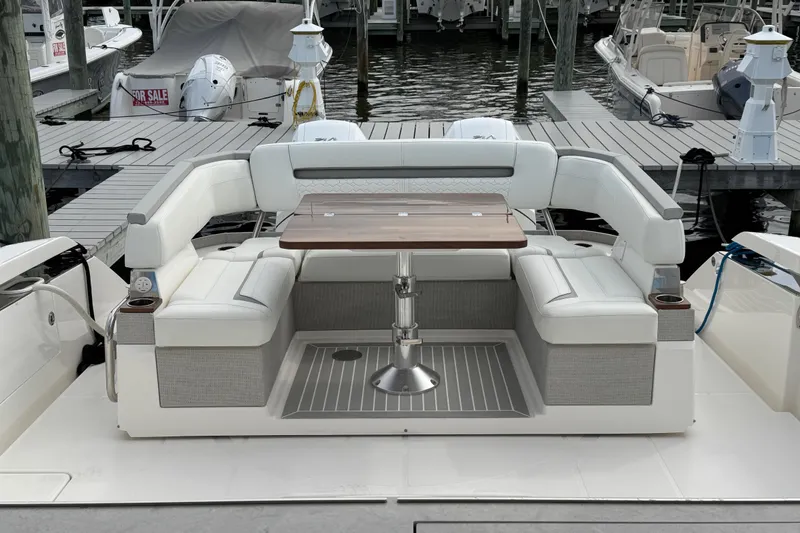 Slide: The Image of 2023 Tiara Yachts 43 LS with elegant seating and table at marina dock. - 28