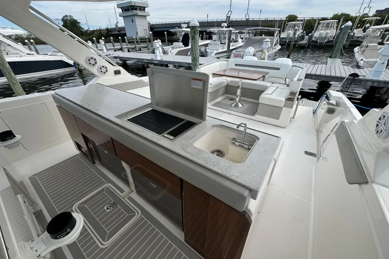 Slide: The Image of 2023 Tiara Yachts 43 LS yacht interior with kitchenette and seating area at marina. - 31