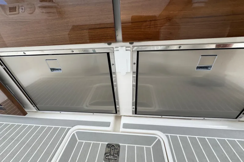 Slide: The Image of Stainless steel storage compartments on 2023 Tiara Yachts 43 LS boat deck. - 33