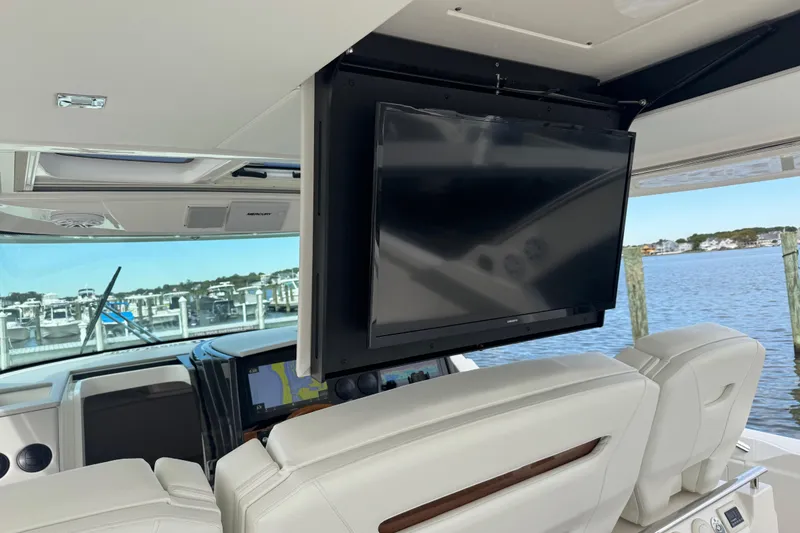 Slide: The Image of 2023 Tiara Yachts 43 LS interior with retractable TV and luxurious seating. - 43