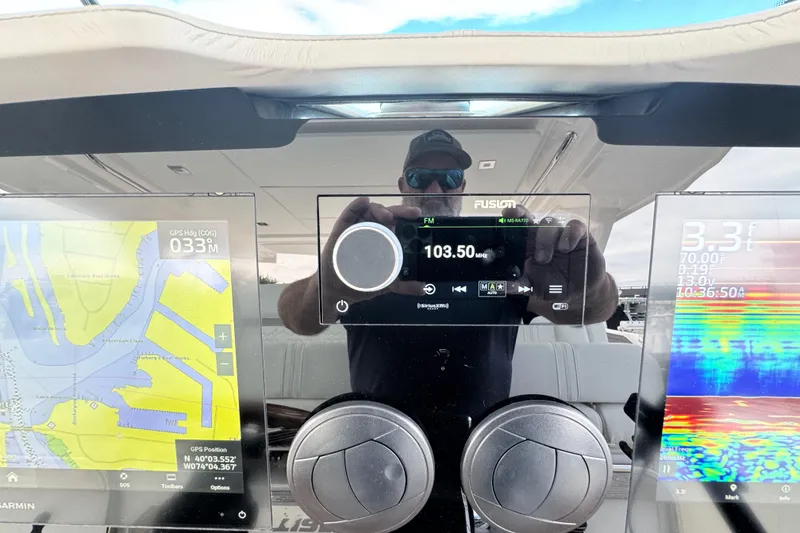 Slide: The Image of Dashboard of 2023 Tiara Yachts 43 LS with navigation and audio controls. - 49