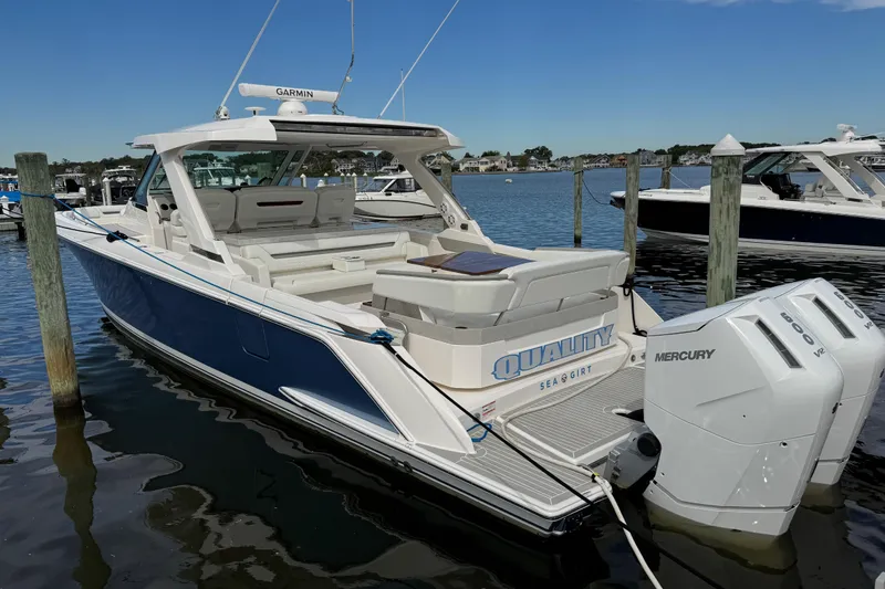 Slide: The Image of 2023 Tiara Yachts 43 LS docked, featuring dual Mercury engines and sleek design. - 5