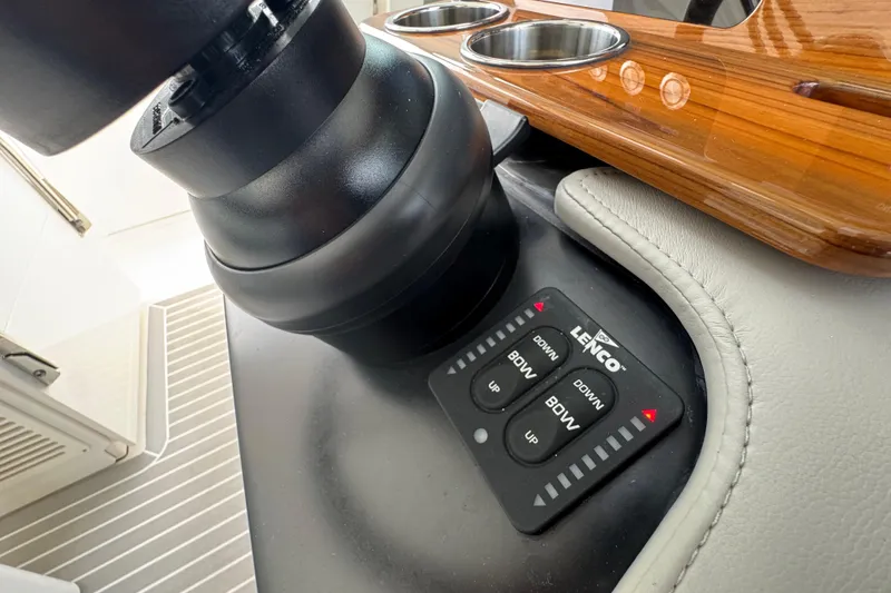 Slide: The Image of 2023 Tiara Yachts 43 LS helm with Lenco trim tab controls and cup holders. - 53