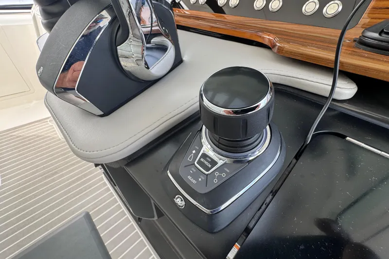 Slide: The Image of Control panel of 2023 Tiara Yachts 43 LS, featuring joystick and throttle controls. - 57