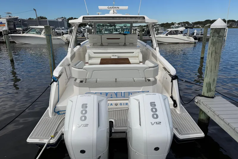 Slide: The Image of 2023 Tiara Yachts 43 LS with twin Mercury 600 V12 engines docked at marina. - 6