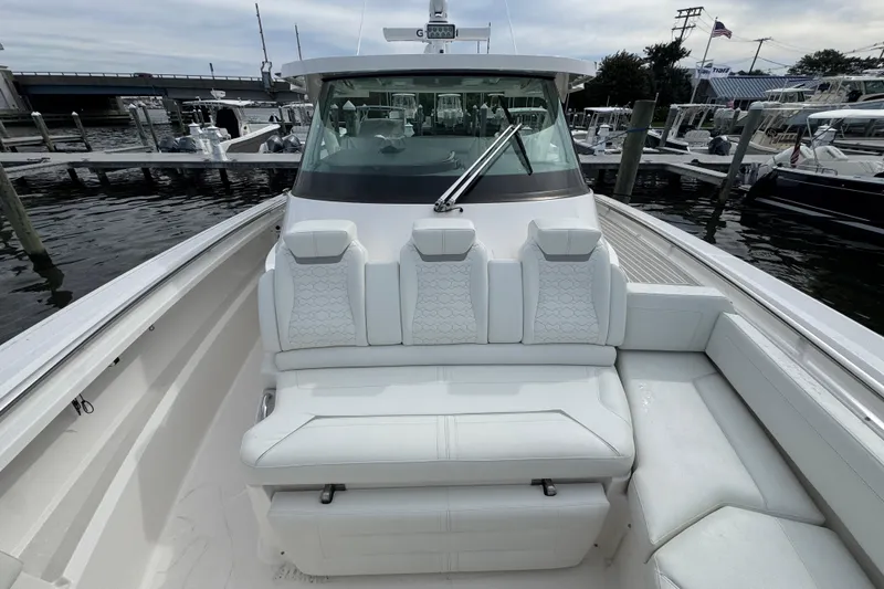 Slide: The Image of 2023 Tiara Yachts 43 LS luxury boat interior with white seating at marina. - 65