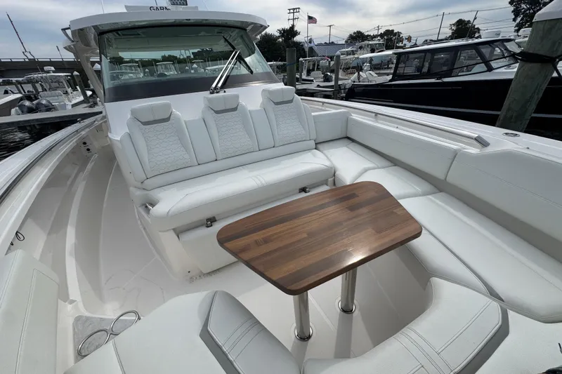 Slide: The Image of 2023 Tiara Yachts 43 LS luxury boat with elegant seating and wooden table. - 66