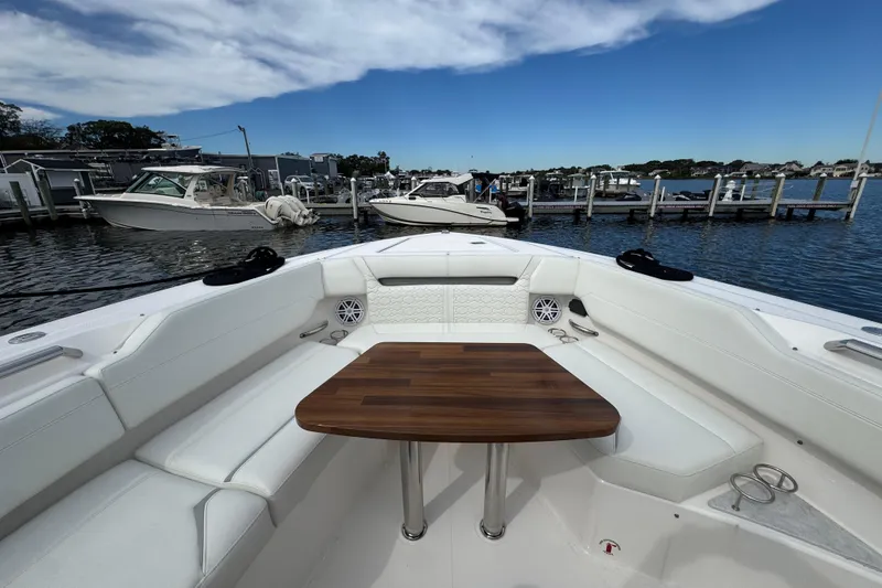 Slide: The Image of 2023 Tiara Yachts 43 LS boat interior with wooden table and white seating. - 67