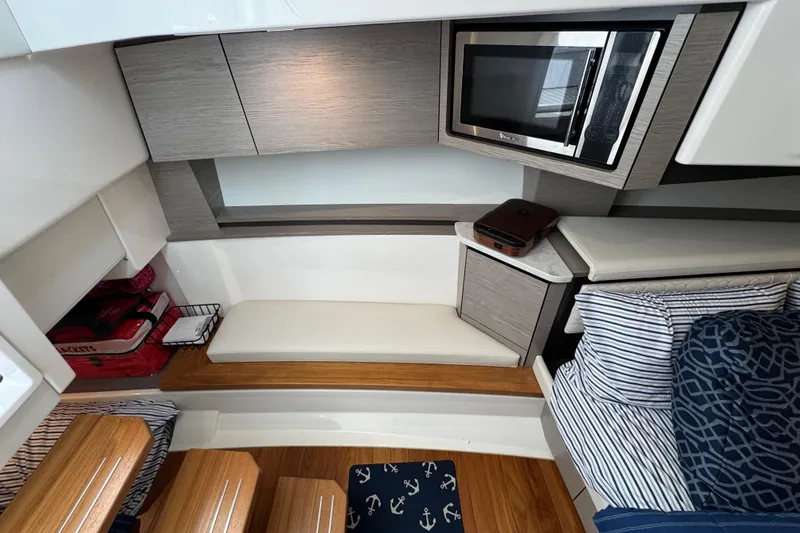 Slide: The Image of 2023 Tiara Yachts 43 LS interior with modern kitchen and cozy seating area. - 72